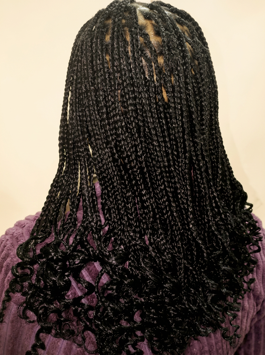 Long black knotless braids with curled tips